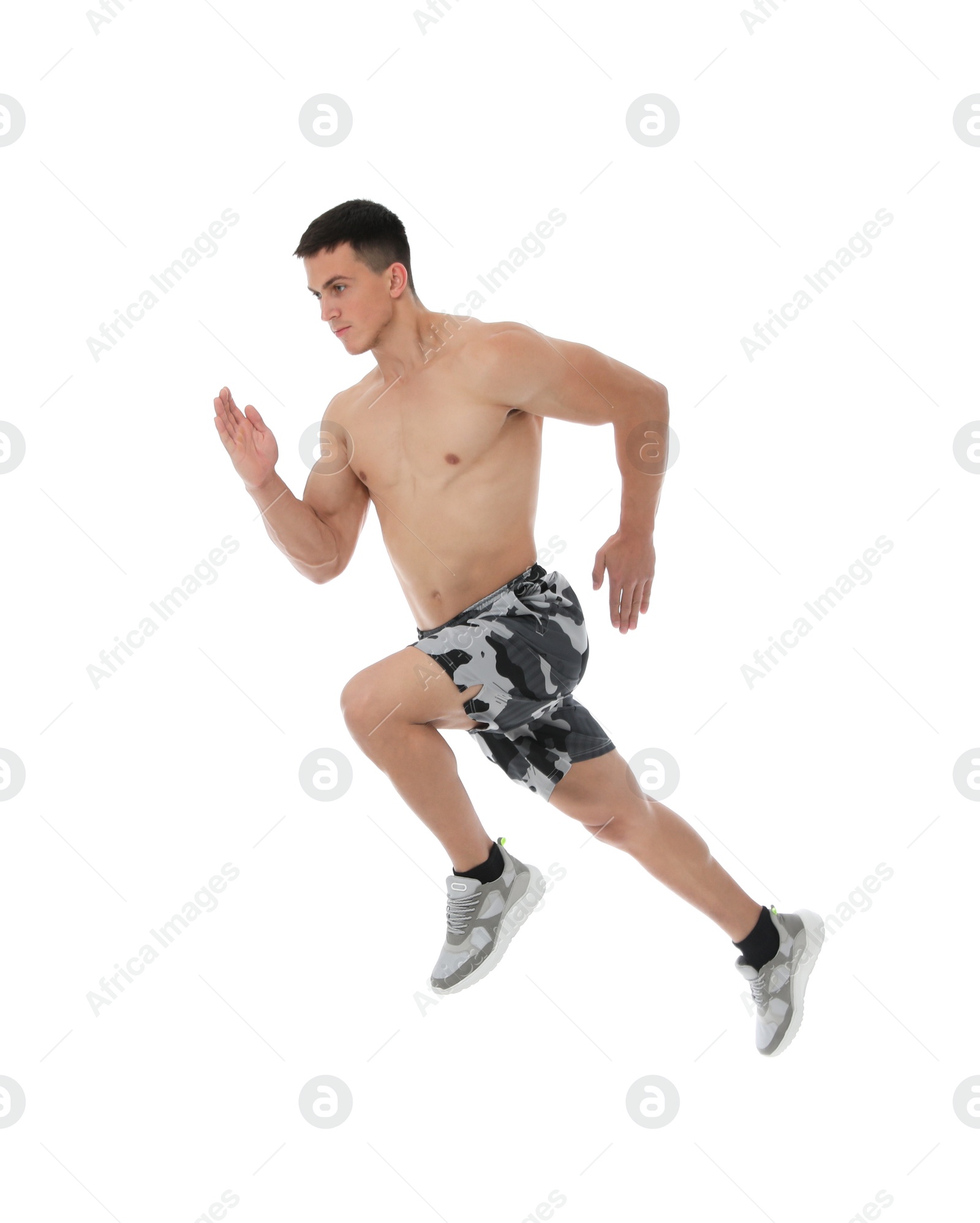 Photo of Athletic young man running on white background, side view