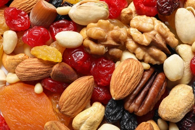 Different dried fruits and nuts as background, closeup