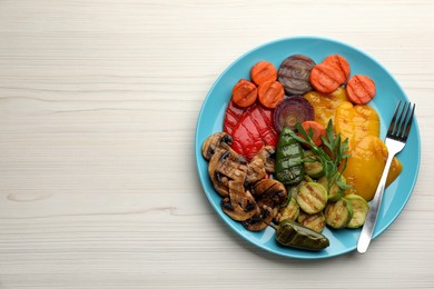 Photo of Delicious grilled vegetables on white wooden table, top view. Space for text