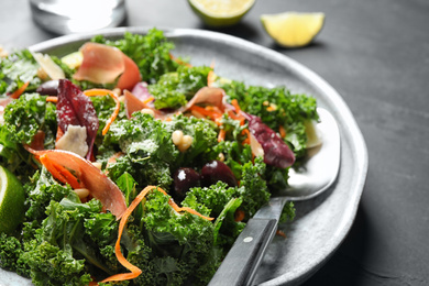 Photo of Tasty fresh kale salad on grey table, closeup