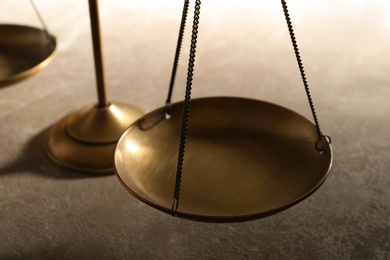 Scales of justice on table, closeup. Law concept