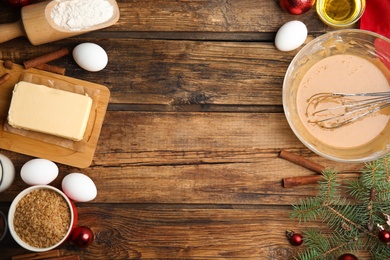 Photo of Flat lay composition with ingredients for traditional Christmas cake on wooden table. Space for text