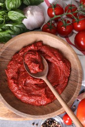 Photo of Tasty tomato paste and ingredients on table, flat lay