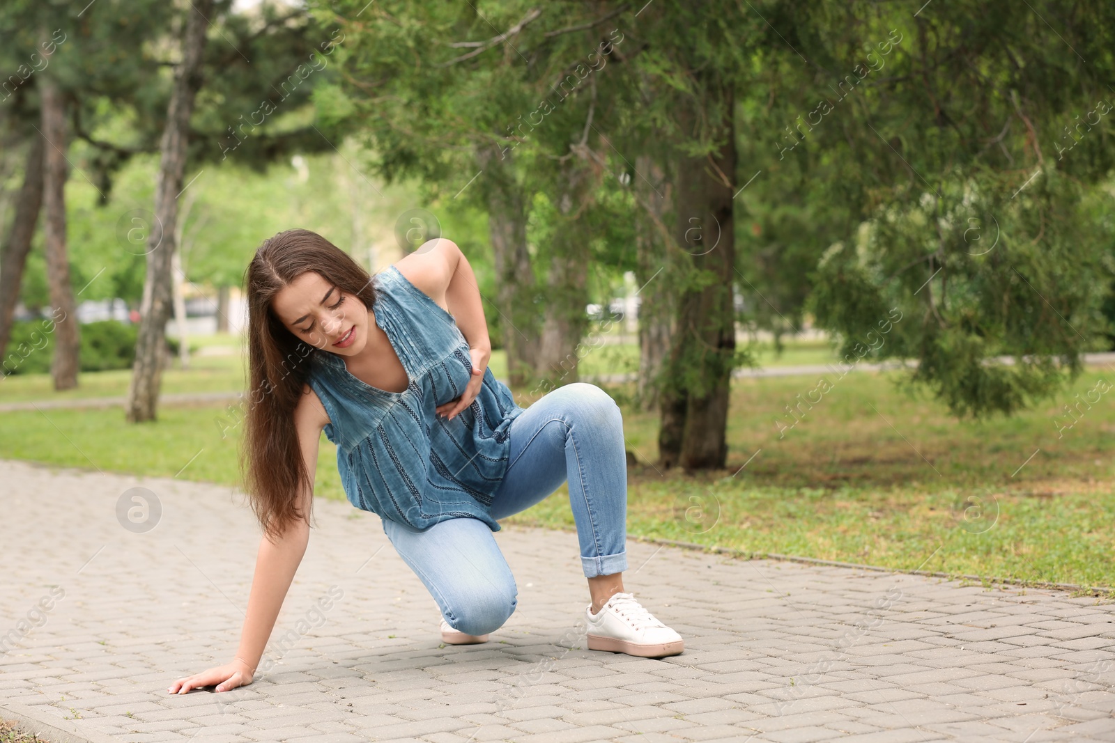 Photo of Young woman having chest pain outdoors. Heart attack