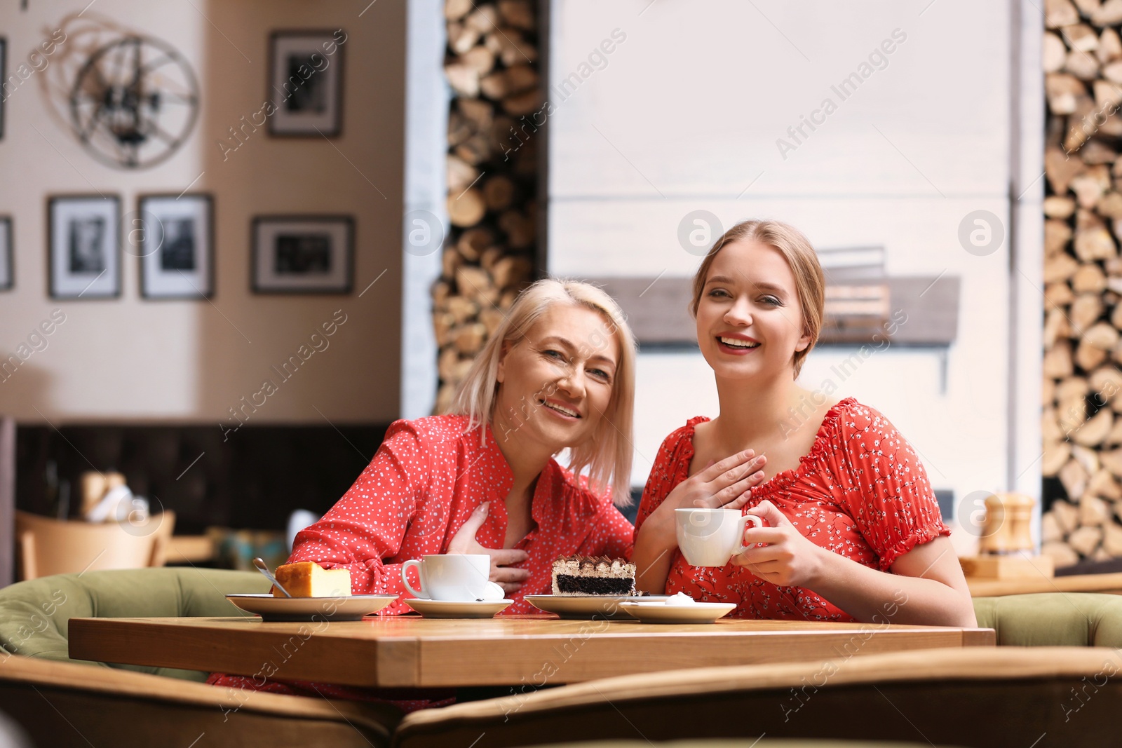 Photo of Mother and her adult daughter spending time together in cafe