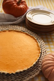 Photo of Delicious homemade pumpkin pie in baking dish on table