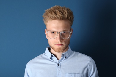 Portrait of handsome young man on blue background