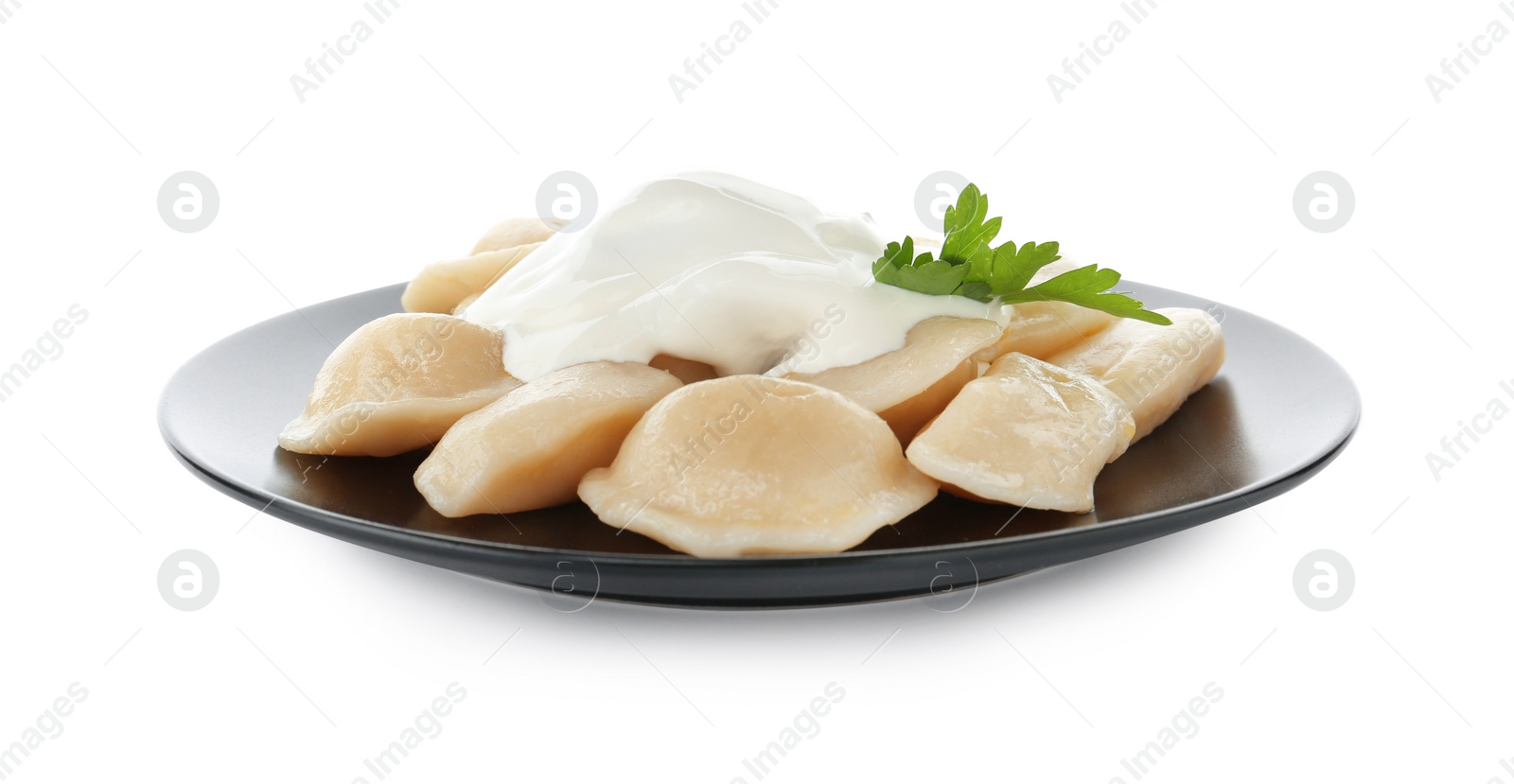 Photo of Delicious cooked dumplings with sour cream on white background