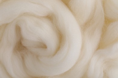 White felting wool as background, closeup view