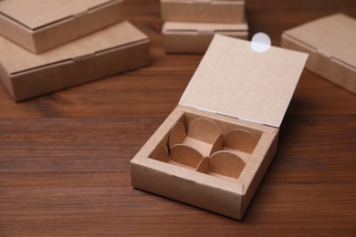 Photo of Empty packaging box with dividers on wooden table. Production line