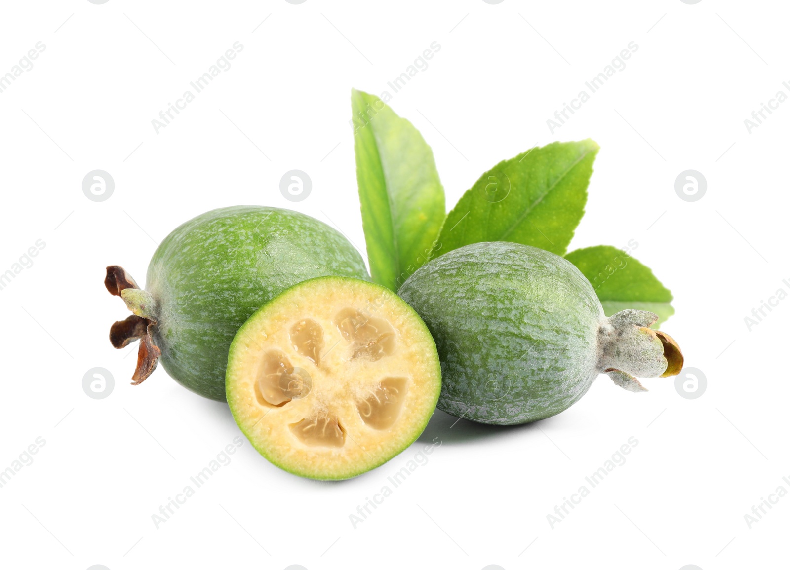 Photo of Cut and whole feijoas with leaves on white background