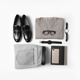 Photo of Stylish male autumn outfit and accessories on white background, flat lay. Trendy warm clothes