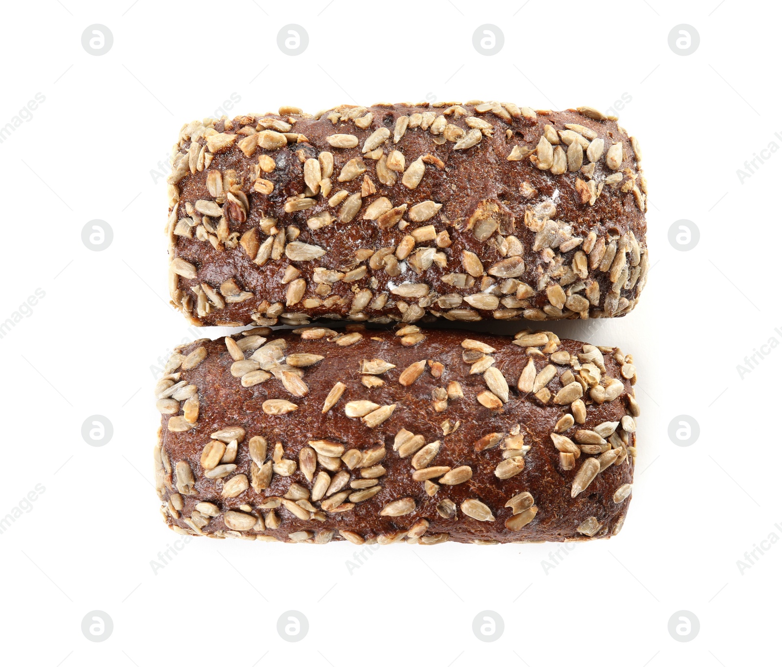 Photo of Loaves of rye bread with sunflower seeds isolated on white, top view