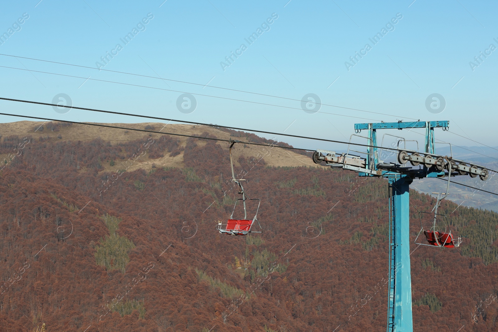 Photo of Chairlift with comfortable seats at mountain resort