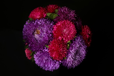 Bouquet of beautiful asters on black background, top view. Autumn flowers