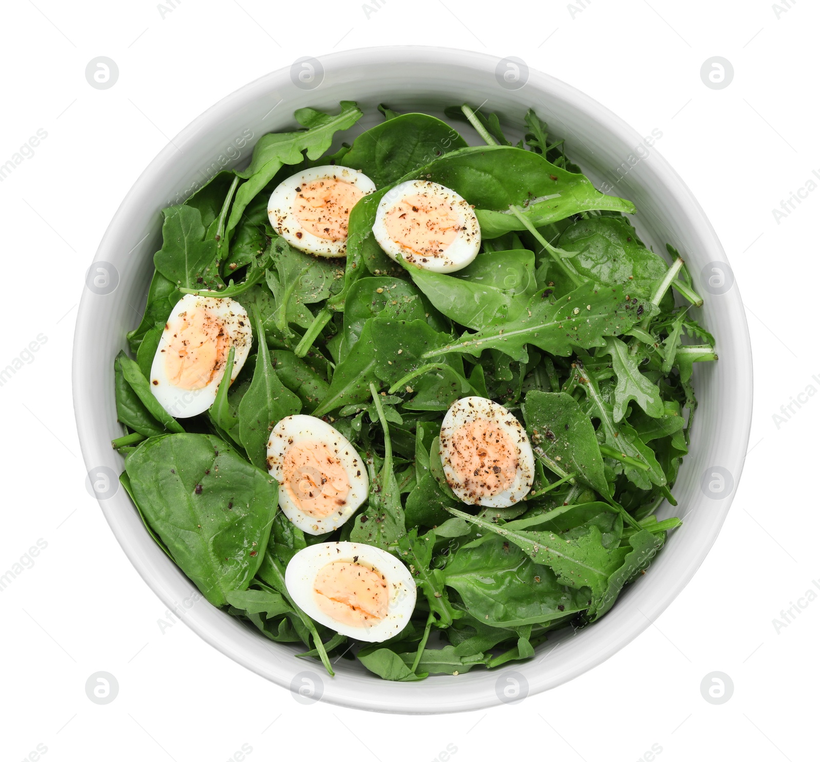 Photo of Delicious salad with boiled eggs and herbs in bowl isolated on white, top view