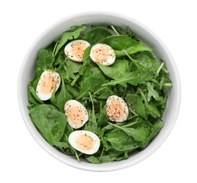 Delicious salad with boiled eggs and herbs in bowl isolated on white, top view