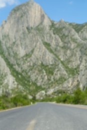Photo of Big mountains and bushes near road, blurred view