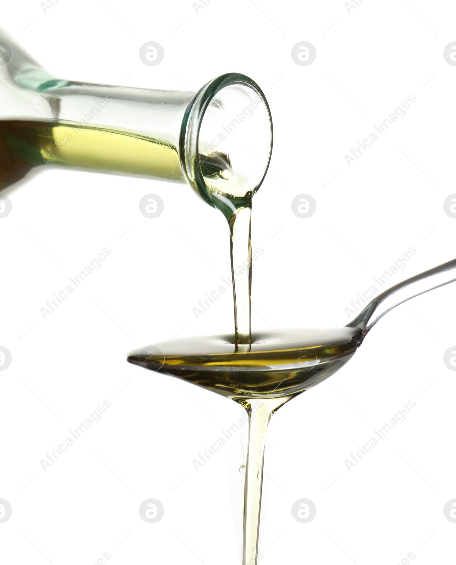 Photo of Pouring fresh olive oil into spoon on white background