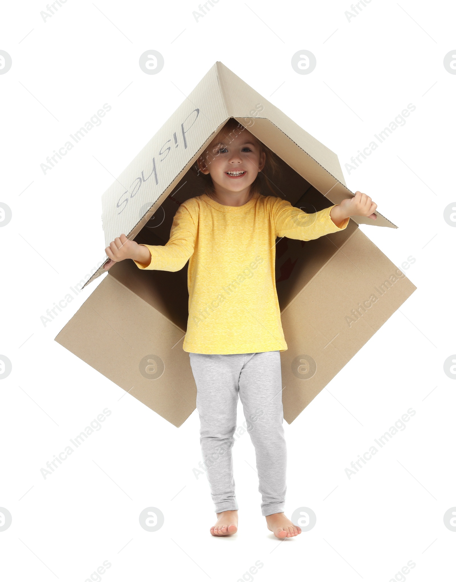 Photo of Cute little girl playing with cardboard box on white background