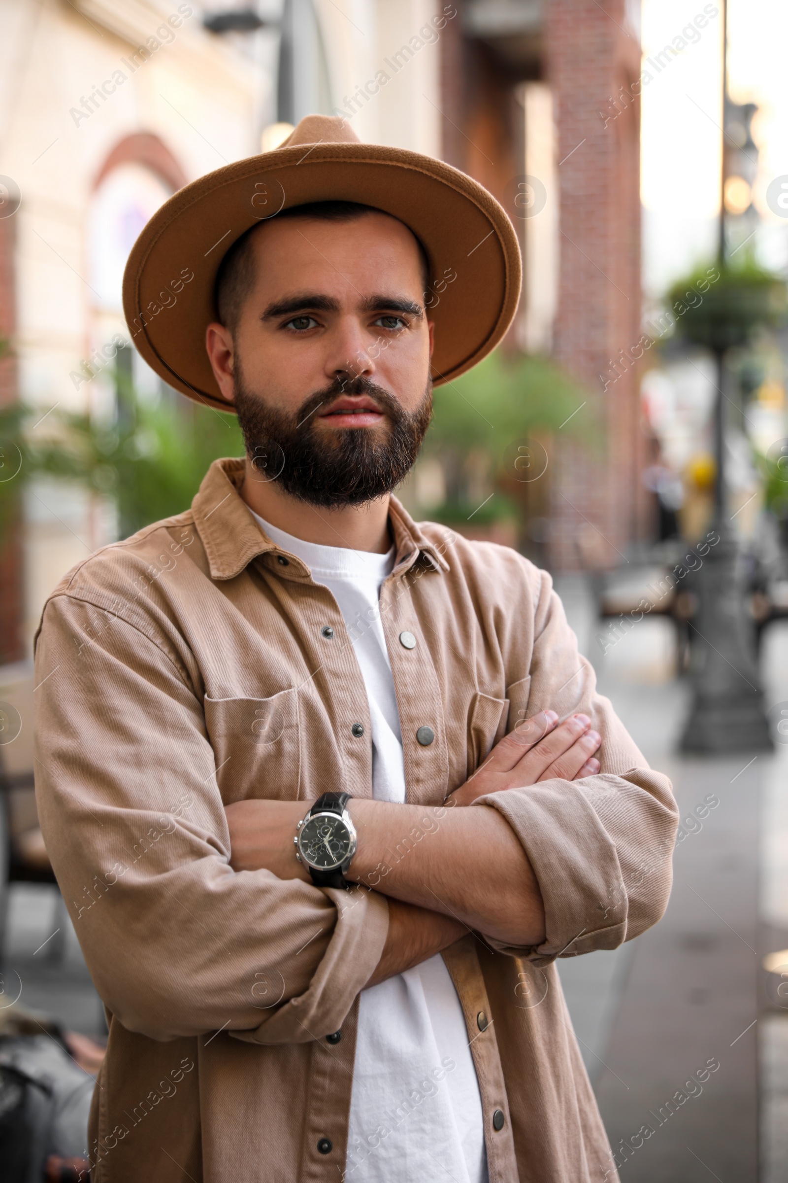 Photo of Portraithandsome bearded man in hat on city street