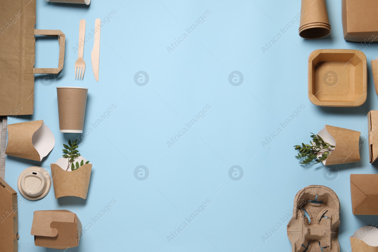 Photo of Flat lay composition with eco friendly food packagings and twigs on light blue background. Space for text