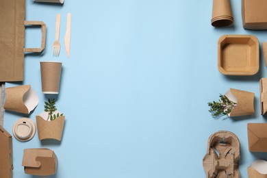 Flat lay composition with eco friendly food packagings and twigs on light blue background. Space for text