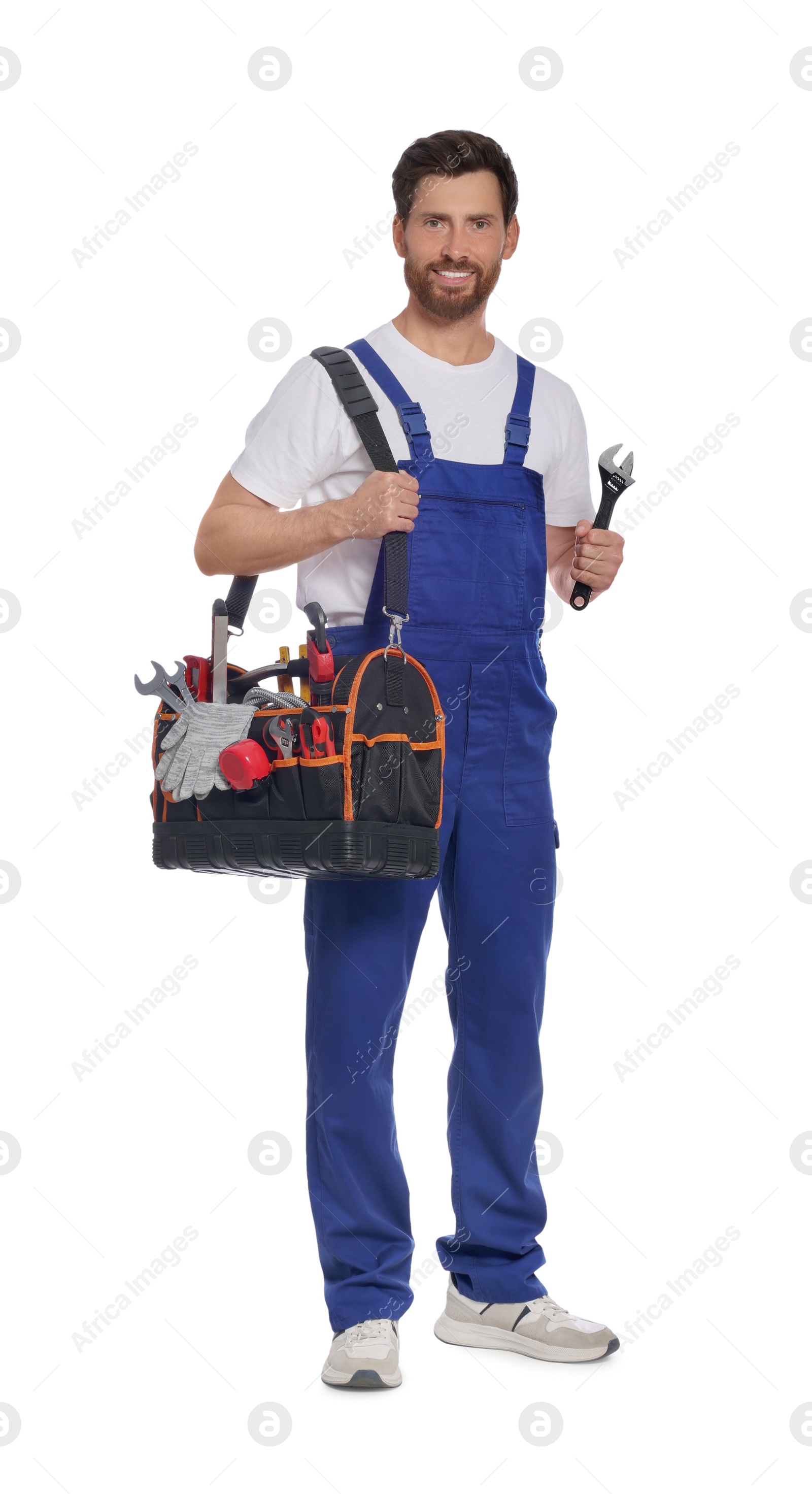 Photo of Professional plumber with tool bag and adjustable wrench on white background