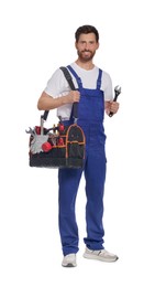 Professional plumber with tool bag and adjustable wrench on white background