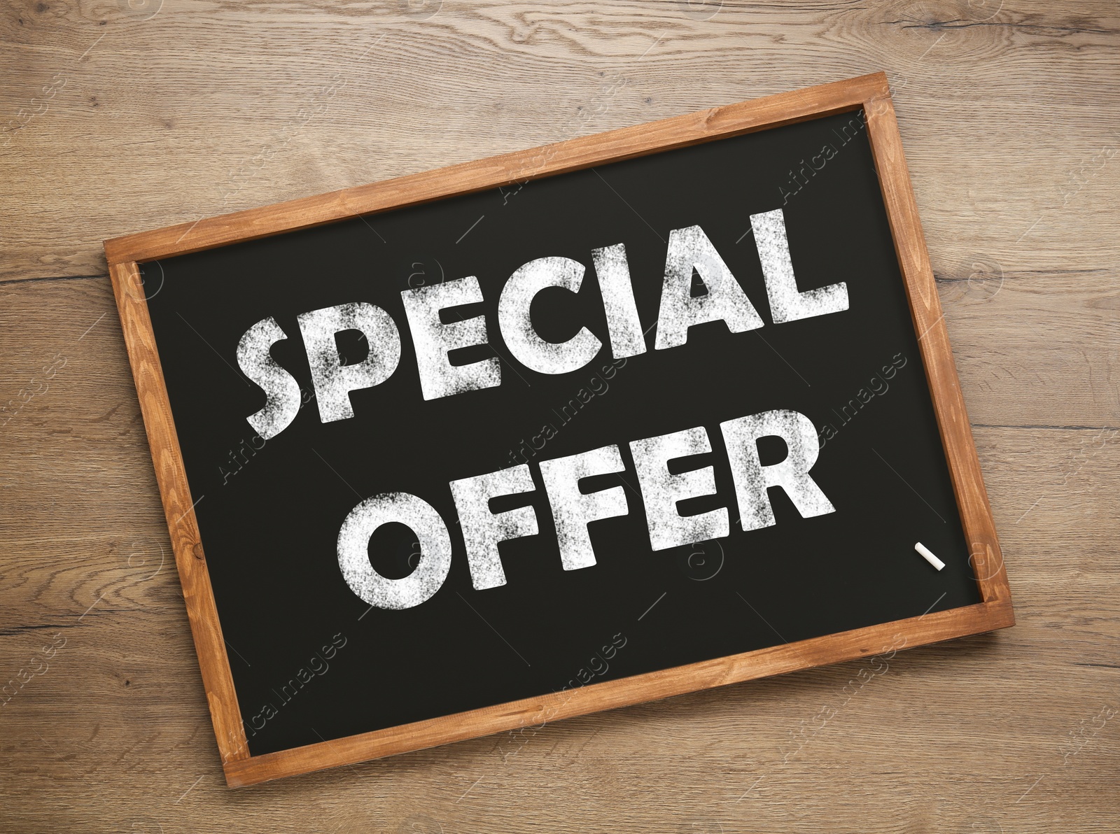 Image of Small blackboard with phrase Special Offer on wooden background, top view