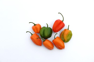 Different hot chili peppers on white background, flat lay