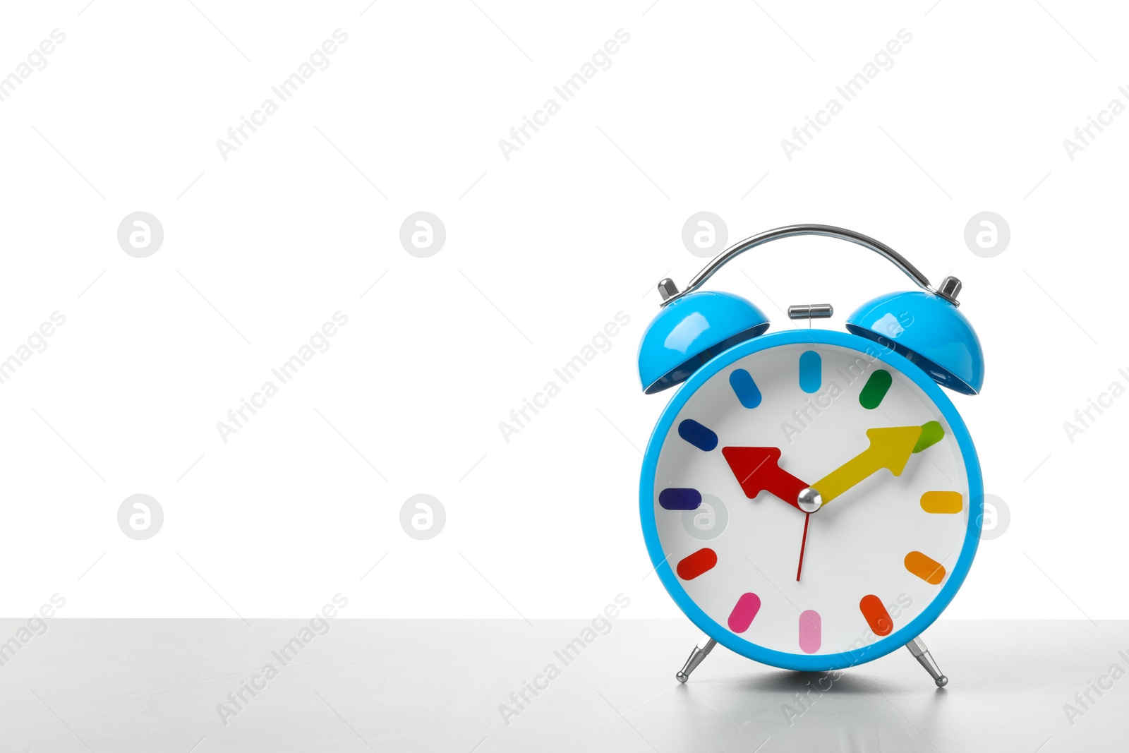 Photo of Alarm clock on table against white background. Time concept