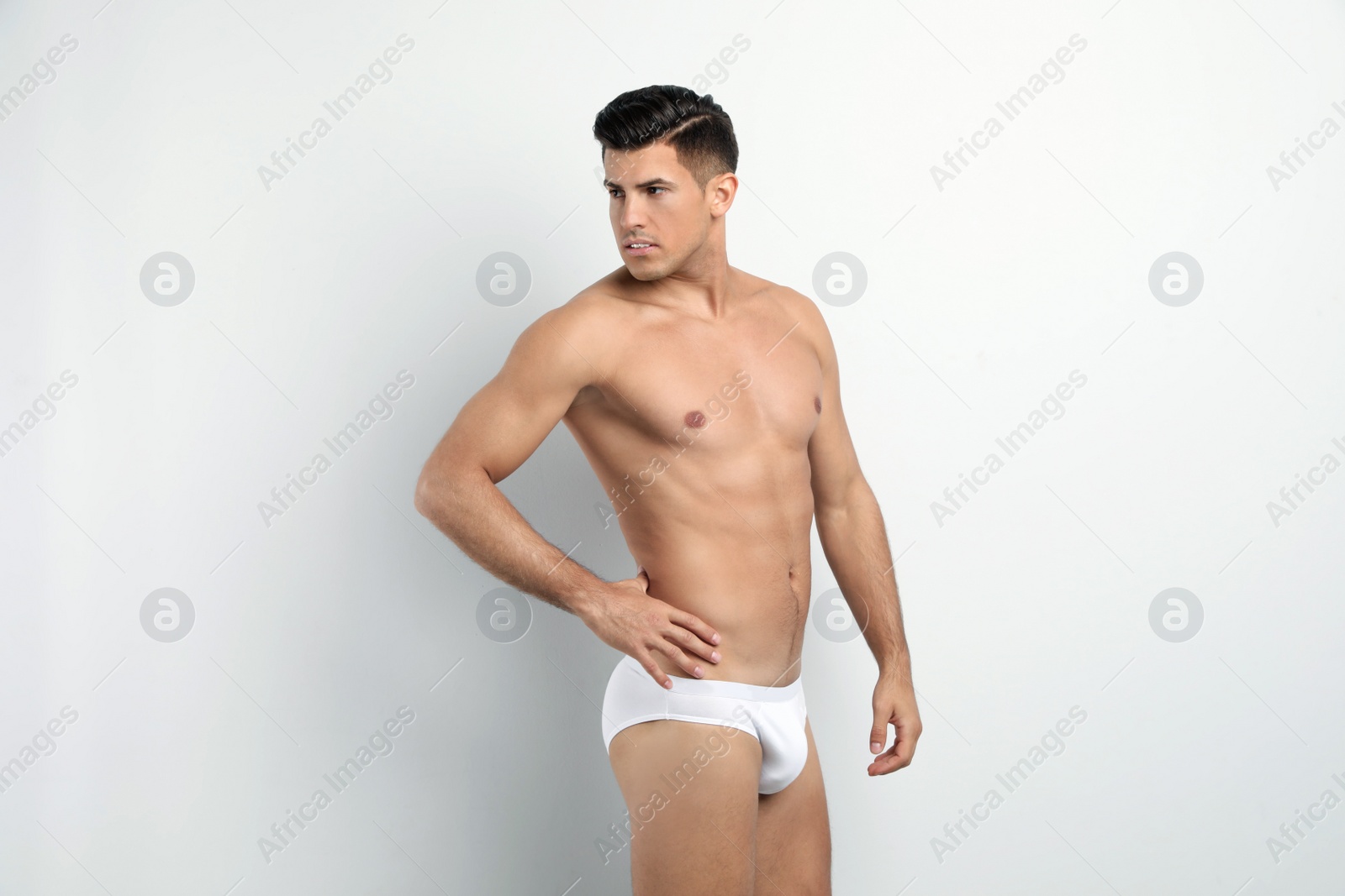 Photo of Handsome man in underwear on white background