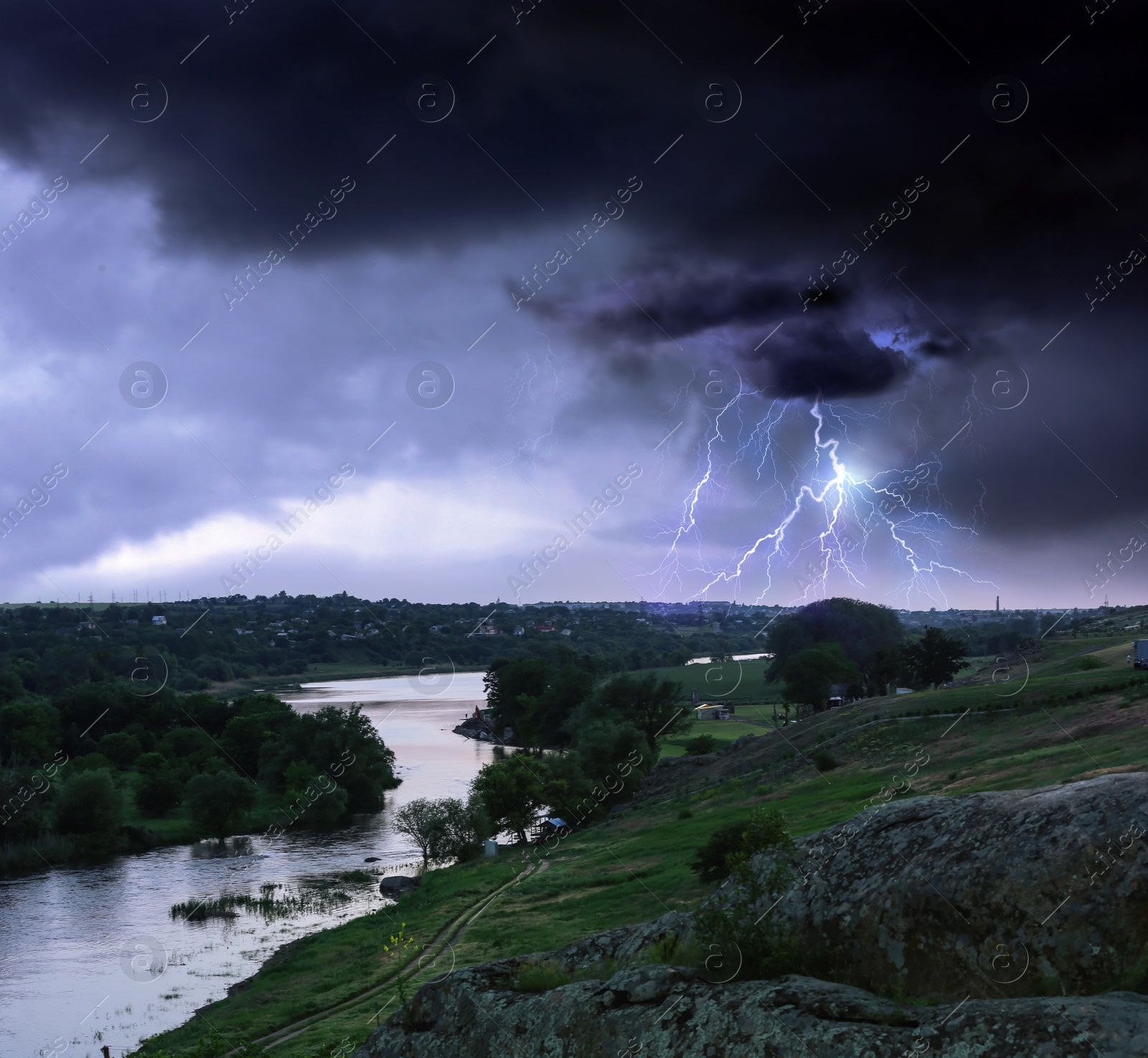 Image of Picturesque thunderstorm over village. Dark cloudy sky with lightnings