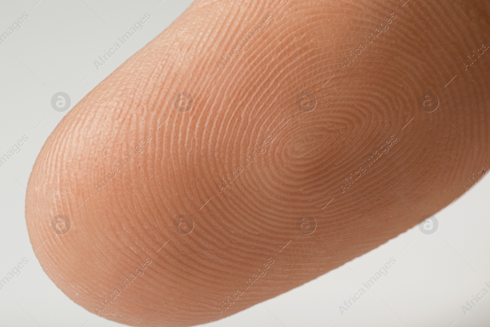 Photo of Closeup view of human finger on white background