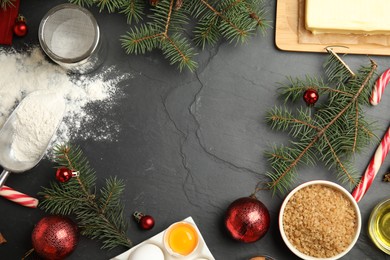 Photo of Flat lay composition with ingredients for traditional Christmas cake on grey table. Space for text