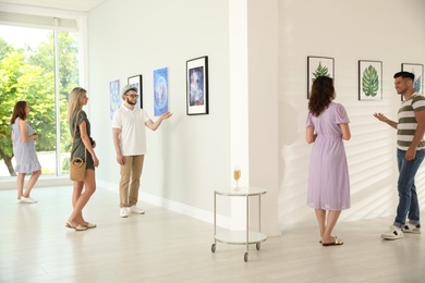 Photo of Group of people at exhibition in art gallery