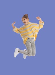 Image of Happy cute girl jumping on light blue background