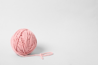 Soft pink woolen yarn on white background