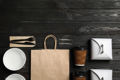 Different containers for mock up design on wooden background, flat lay. Food delivery service