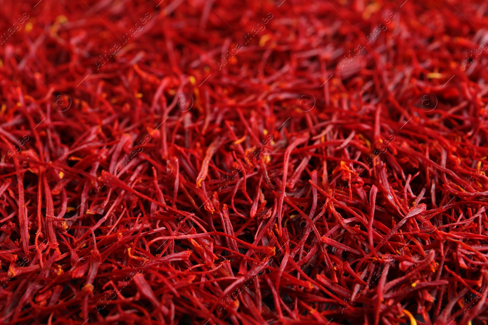 Photo of Aromatic dried saffron as background, closeup view