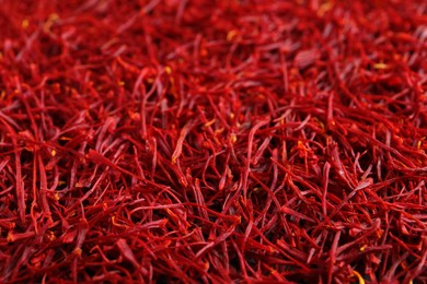 Photo of Aromatic dried saffron as background, closeup view