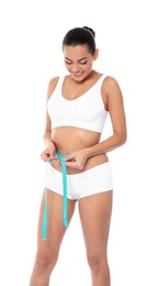 Photo of Slim woman measuring her waist on white background. Weight loss