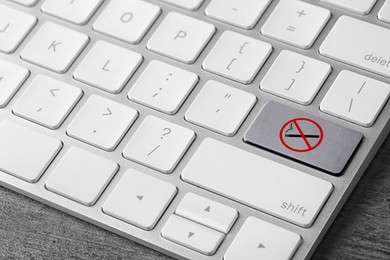 Grey button with sign No smoking on computer keyboard, closeup