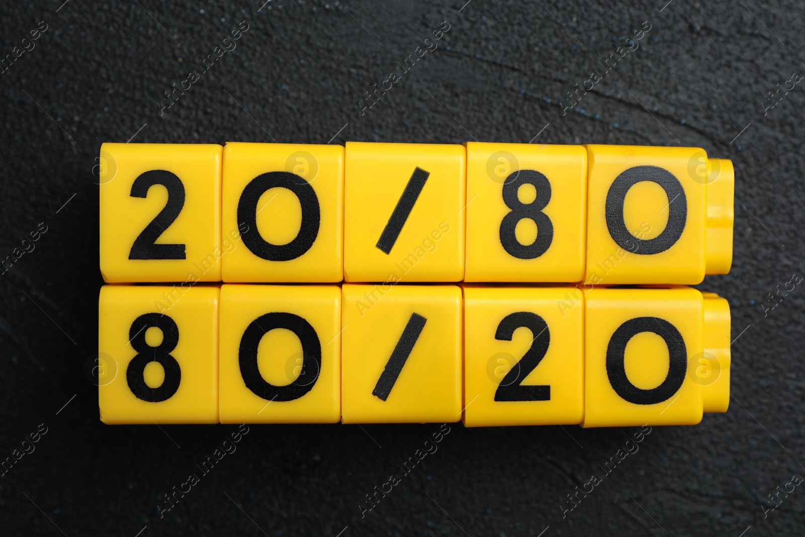 Photo of Yellow blocks with numbers 20 and 80 on black stone background, flat lay. Pareto principle concept