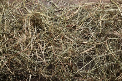 Dried hay on wooden table, top view