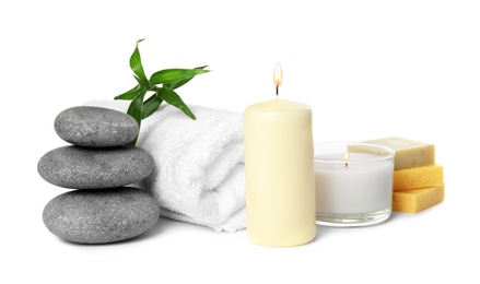 Photo of Beautiful spa composition with candles and stones on white background