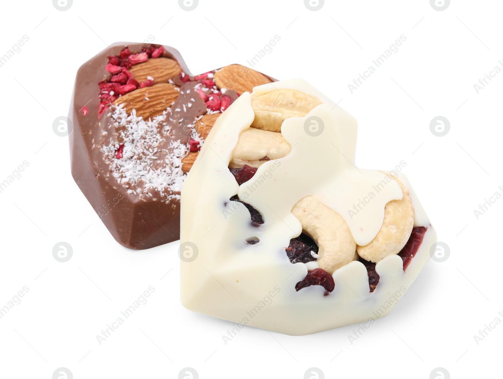 Photo of Tasty chocolate heart shaped candies with nuts on white background