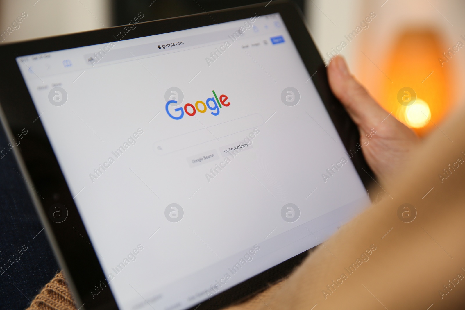 Photo of MYKOLAIV, UKRAINE - OCTOBER 31, 2020: Woman using Google search engine on tablet indoors, closeup