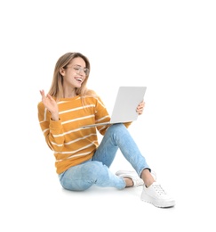 Photo of Young woman in casual outfit with laptop sitting on white background